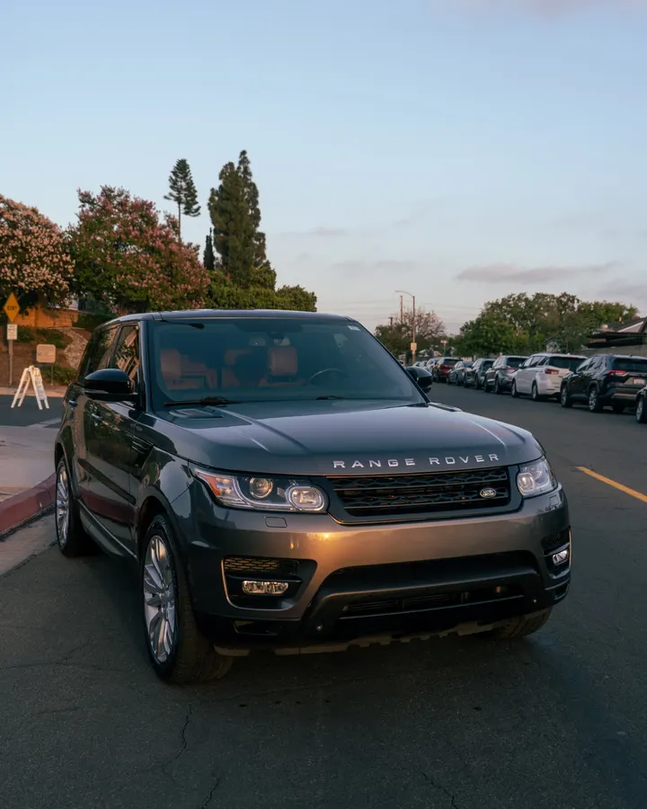 Gray Range Rover Sport with glossy paint on a San Francisco street at dusk